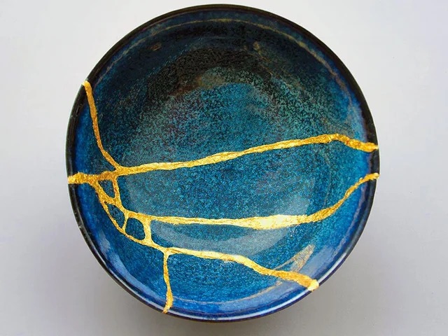 Kintsugi bowl, broken pottery mended with gold